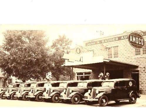 An outside view of John Sauder Chevrolet with vehicles parked in front